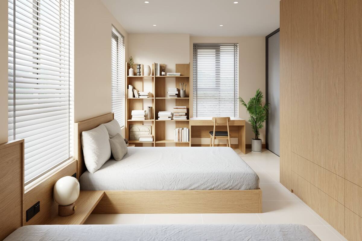 A modern bedroom with a large bed, a desk, and a bookshelf.