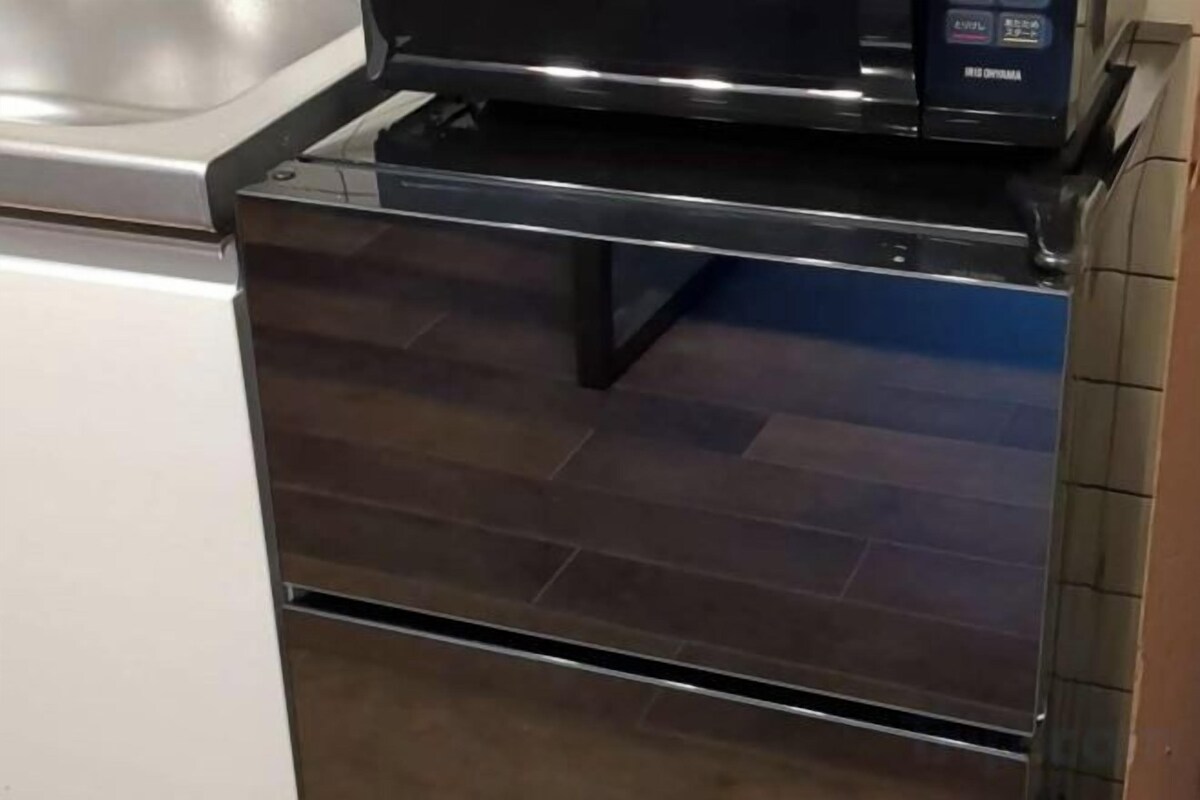 A stainless steel oven with a digital display.