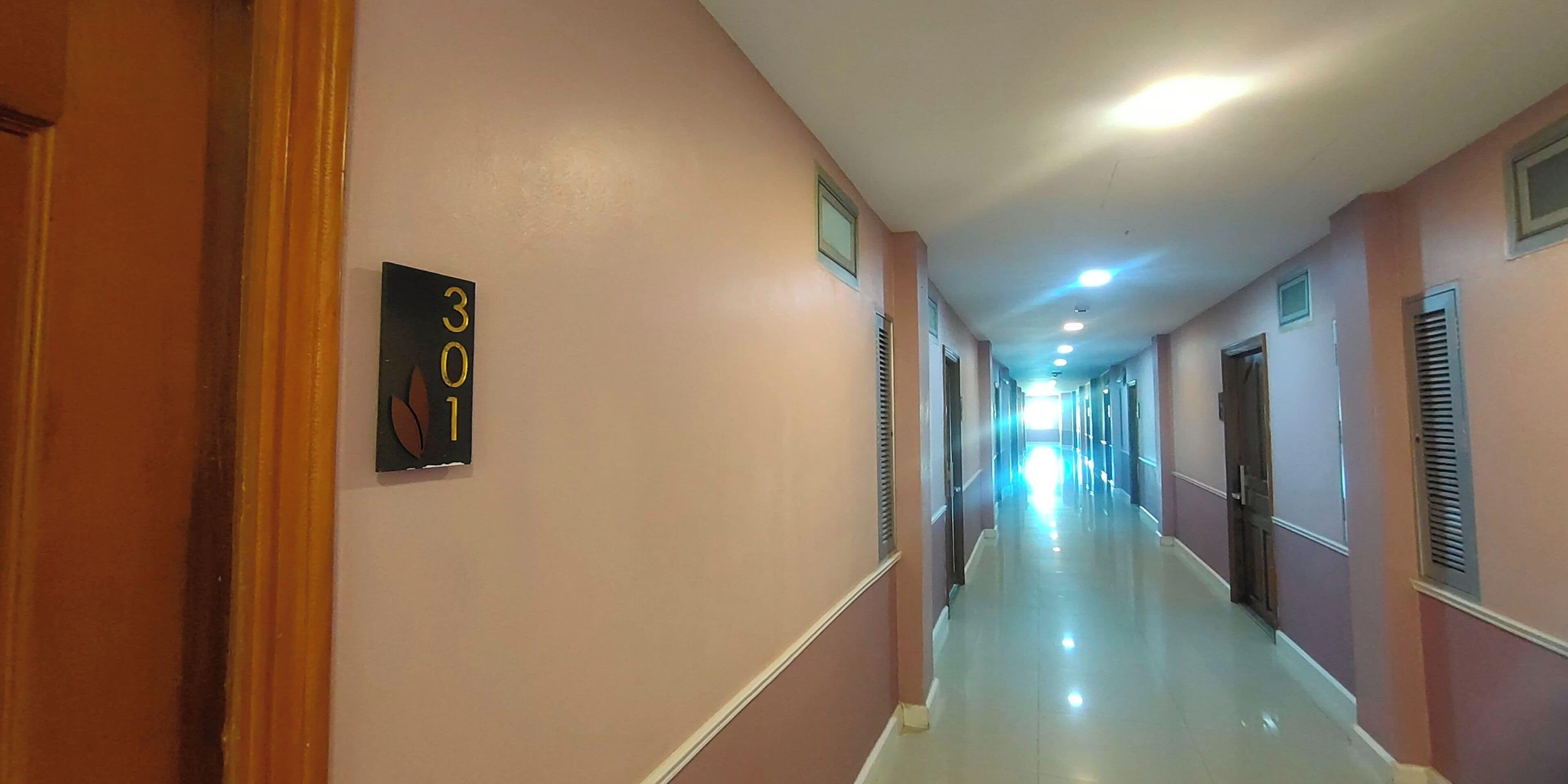 A corridor with a sign indicating room number 301.