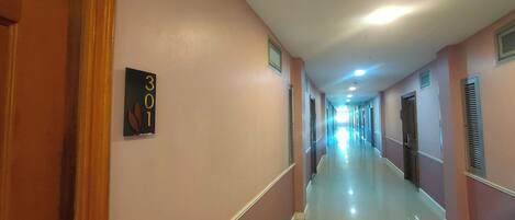 A corridor with a sign indicating room number 301.