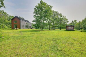 A modern house with a large lawn, a small gazebo, and a large tree. - Hudson Valley Summer Escape w/ Pool & Fire Pit (Pine Plains)