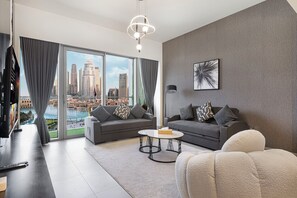 Luxury Apartment, 2 Bedrooms, Private Pool, Lake View | Living room | 65-inch Smart TV with cable channels, Netflix, Hulu - Grande Suites by Hostiva - Burj View (Dubai)