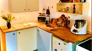 A compact kitchen with a microwave, kettle, and a small refrigerator. - Room 'Sternenzimmer' with Wi-Fi (KASSEL)