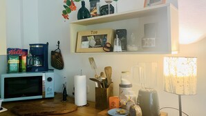 A kitchen with a coffee maker, kettle, microwave, and various kitchen utensils. - Room 'Sternenzimmer' with Wi-Fi (KASSEL)