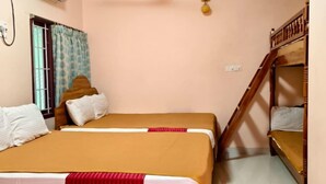 A bedroom with two beds, a ceiling fan, an air conditioner, and a window with curtains. - Farmdean Holiday Home (Nagercoil)