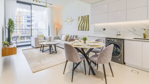 A modern apartment with a dining area, kitchen, and living room. - Binghatti Lavender Residences- JVC (Dubai)