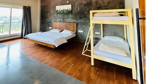 A bedroom with a bunk bed, a ceiling fan, a large window, and a view of the outdoors. - Hillock Vista Homestay by Aarika Resorts (Sakleshpur)
