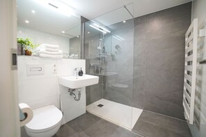 Shower, hair dryer, towels, toilet paper