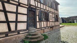 A traditional half-timbered building with a cobblestone courtyard.