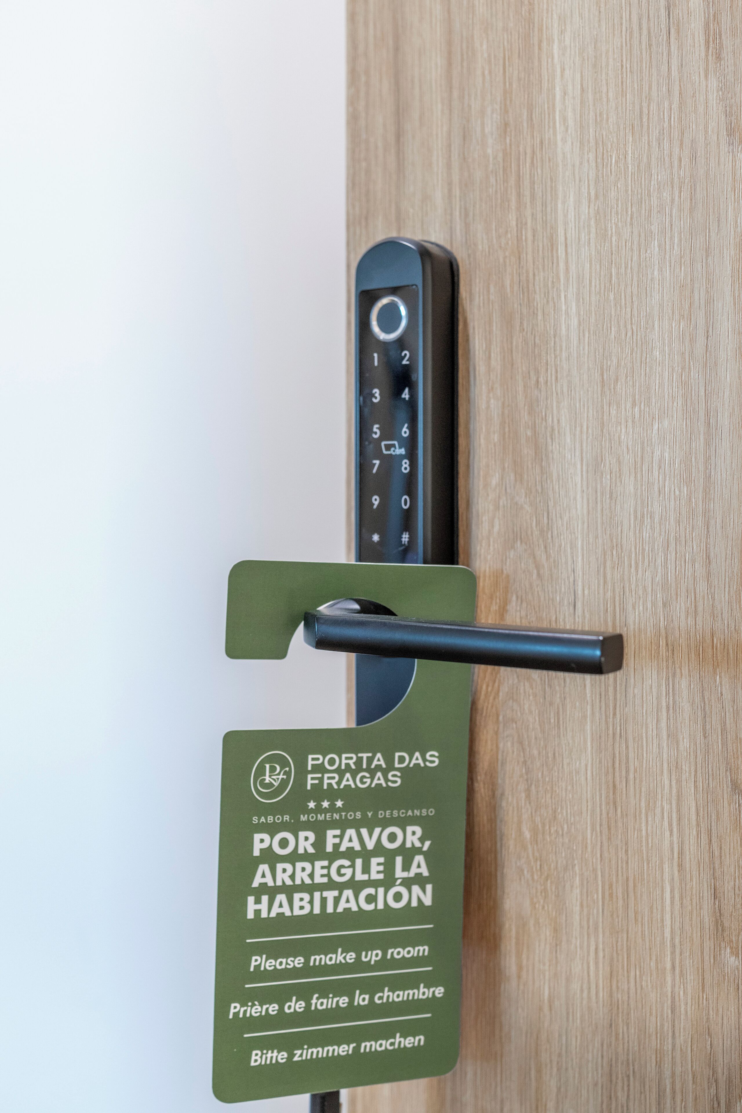 A hotel room door with a keypad and a sign instructing to make up the room.