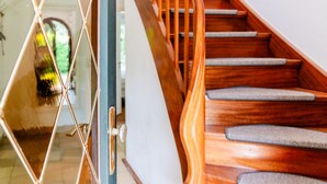 A wooden staircase with a handrail and carpeted steps. - Holiday Home 'Seeblick' with Sea View, Private Terrace and Wi-Fi (Langballig)