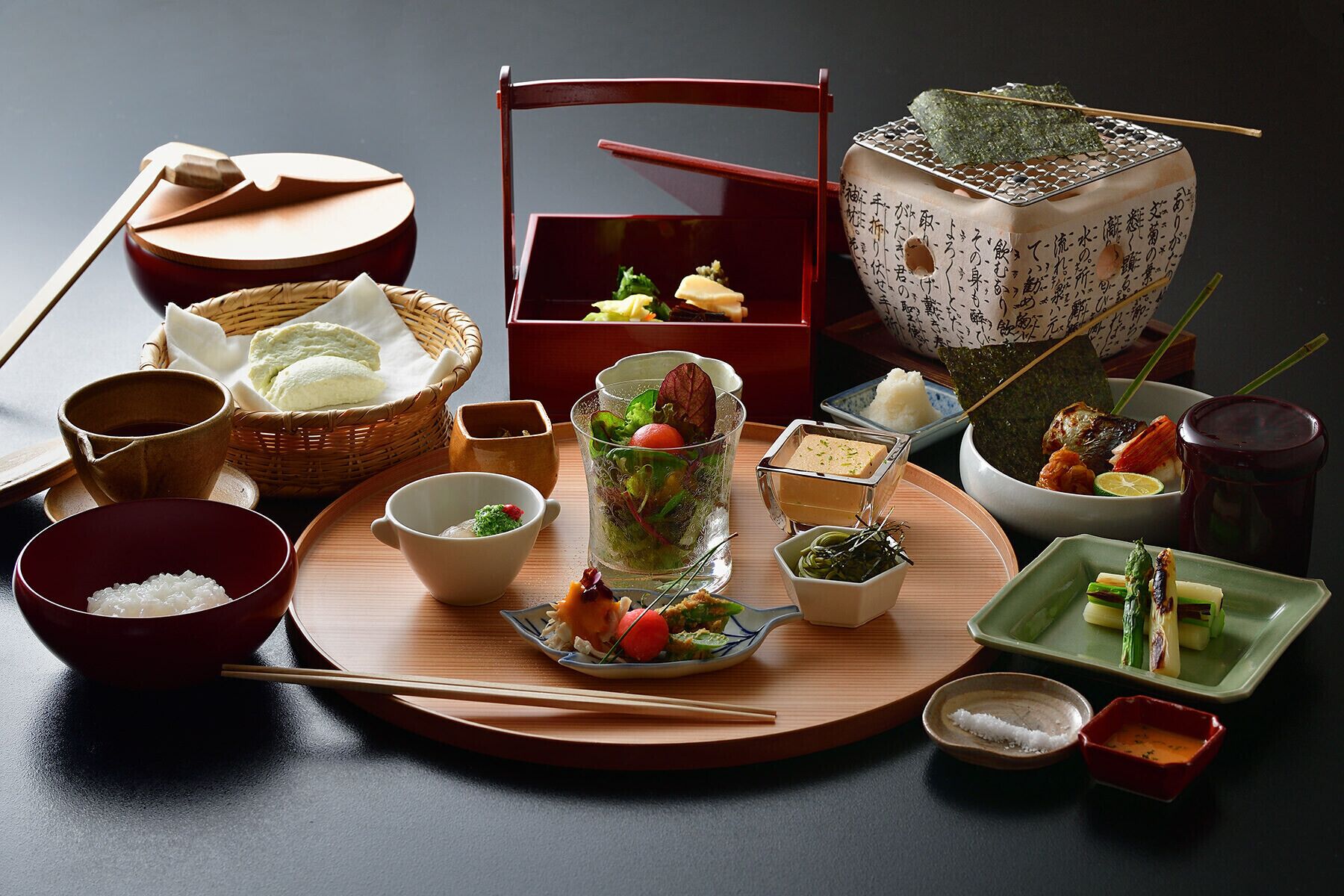 A traditional Japanese meal setup with various dishes and utensils.