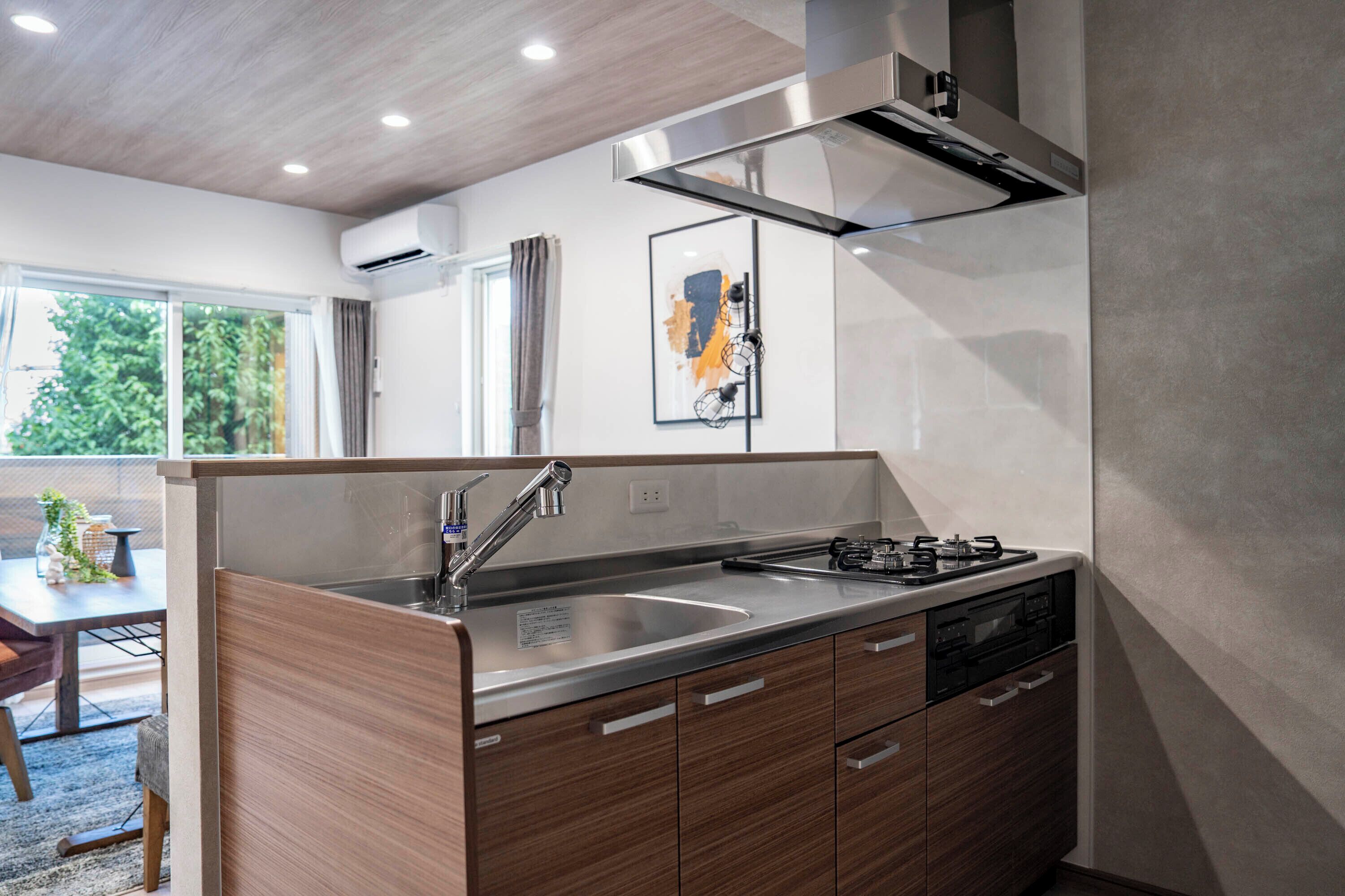 A modern kitchen with a built-in sink, stainless steel appliances, and wooden cabinetry.