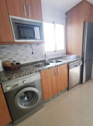 Fridge, microwave, stovetop, dining tables