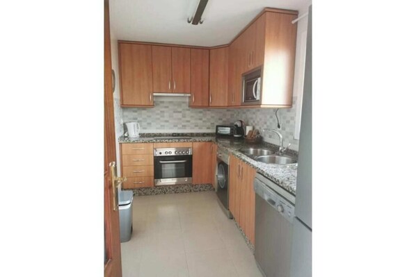 Fridge, microwave, stovetop, dining tables