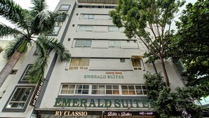 A building with the sign "Emerald Suites" and "By Classio" on the ground floor. - Emerald Suites By Classio (Bengaluru)