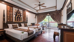 A spacious hotel room with a large bed, a ceiling fan, and a balcony with a view. - Le Ayodhaya Palace Krabi Beach Resort (Krabi)