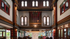 A spacious lobby with high ceilings, large windows, and traditional wooden furnishings. - Le Ayodhaya Palace Krabi Beach Resort (Krabi)