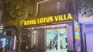 A building with a sign reading "ROYAL LOTUS VILLA" and a staircase leading to the entrance. - Royal Lotus Villa (Hanoi)