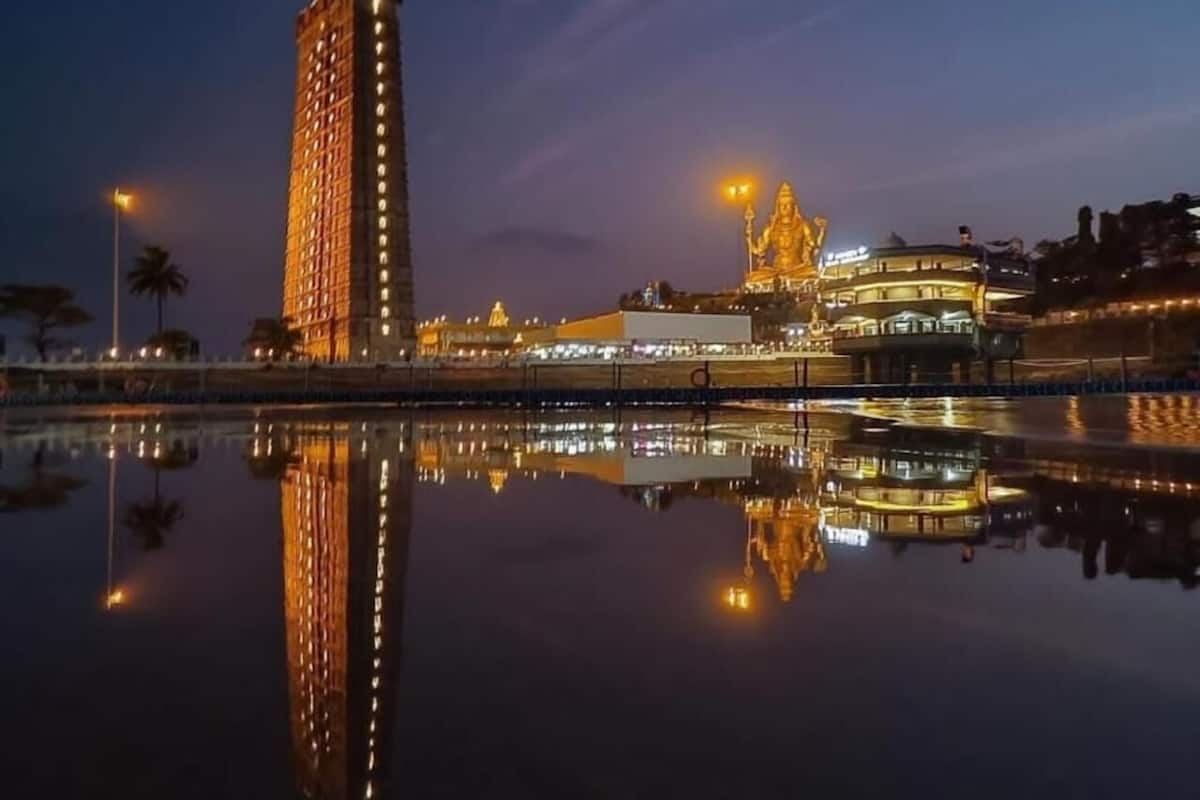 A high-rise hotel with a reflection in the water, a temple with a golden statue, and a building with a dome.