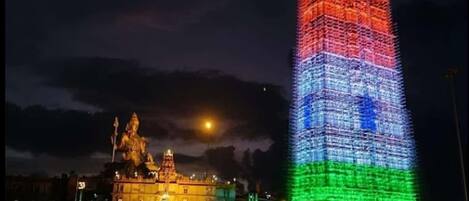 A tall building with a colorful facade at night.