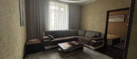 Comfort Apartment, City View | Living area | 35-inch flat-screen TV with satellite channels