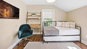 A bedroom with a bed, a desk, a chair, a window, and a ceiling light. - Call Me Old Fashioned! *Heart of Bardstown Square* (Bardstown)