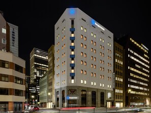 A multi-story building with a prominent 'Bangkok Bank' sign at the top. - Hotel Villa Fontaine Tokyo Hibiya (Tokyo)