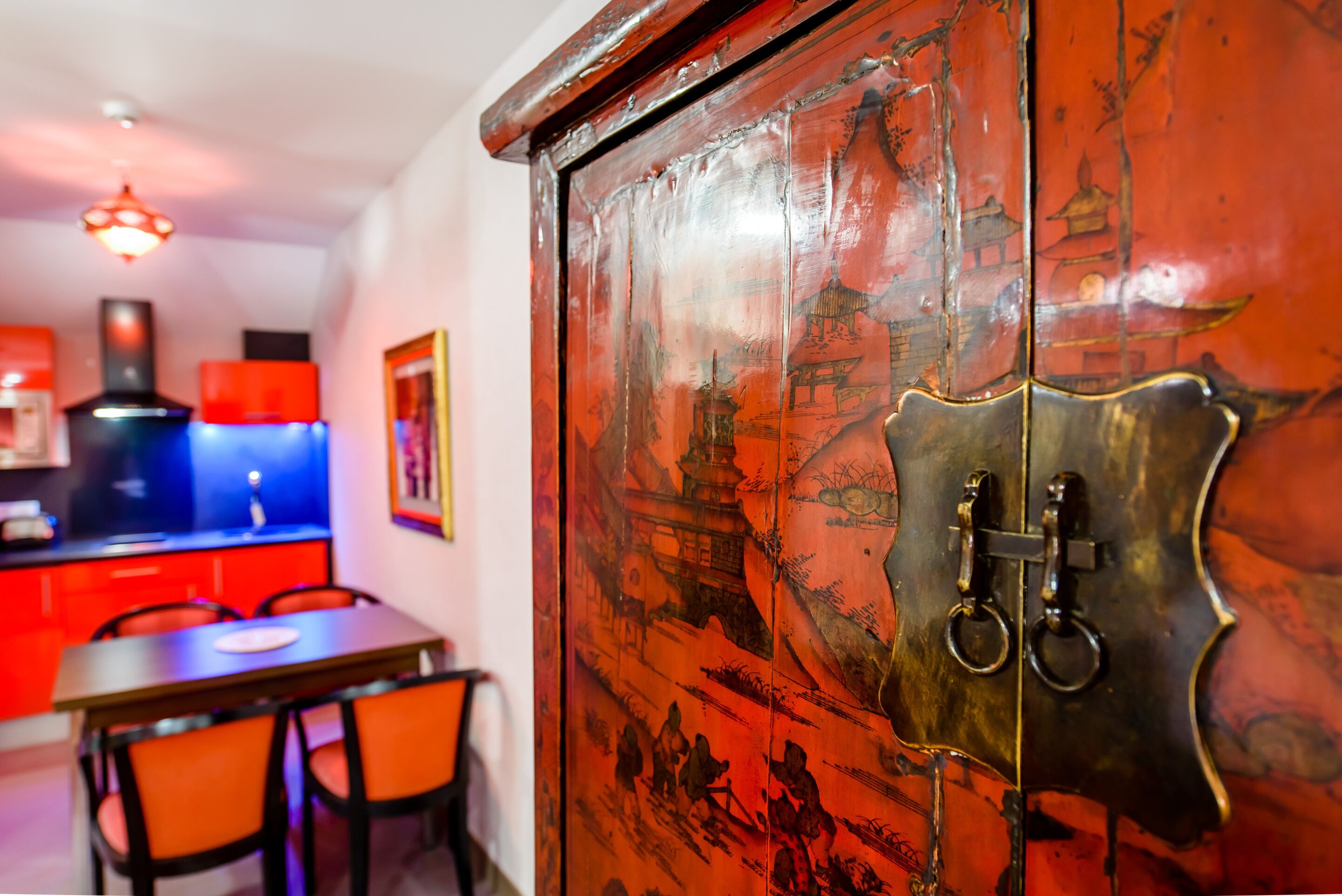 A traditional wooden cabinet with intricate carvings and a brass lock mechanism.