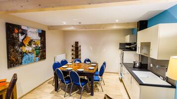 A modern kitchen with a dining area.