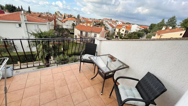 A balcony with tiled flooring, two wicker chairs, a small table, and a metal railing. - App Villa Palma 2 (Rovinj)