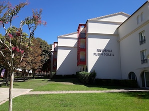 A building with a sign reading 'RESIDENCE PLEIN SOLEIL' indicating a residential property.