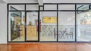 A reception area with a sign reading "Season 4 Reception" and a tiled wall behind the reception desk. - Season4 Residences 1-BHK furnished appt (Chennai)