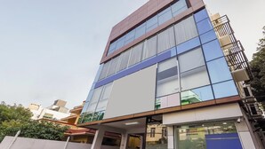 A multi-story building with large windows and balconies. - Season4 Residences 1-BHK furnished appt (Chennai)