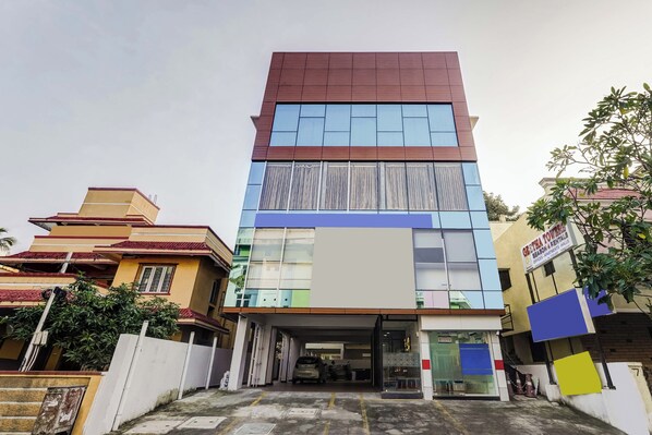 A multi-story building with a modern design, featuring a mix of glass and solid panels.