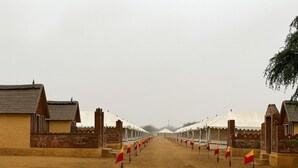 A row of traditional tents with a sandy ground, arranged in a linear fashion. - Talai Desert Camp (Jaisalmer)