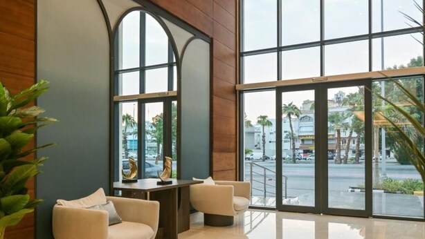 A modern lobby with a seating area, large windows, and a view of the street. - Tiara hotel (Jeddah)