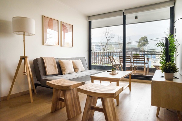 Relax in this stylish living room with balcony access, perfect for soaking in the views and unwinding in comfort.