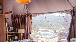 A tented accommodation with a bed, chairs, a table, and a view of the landscape. - EcoHouse Glamping by ART HOTEL (Bishkek)