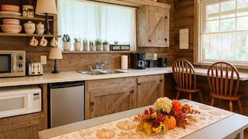 Fridge, microwave, coffee/tea maker, cookware/dishes/utensils