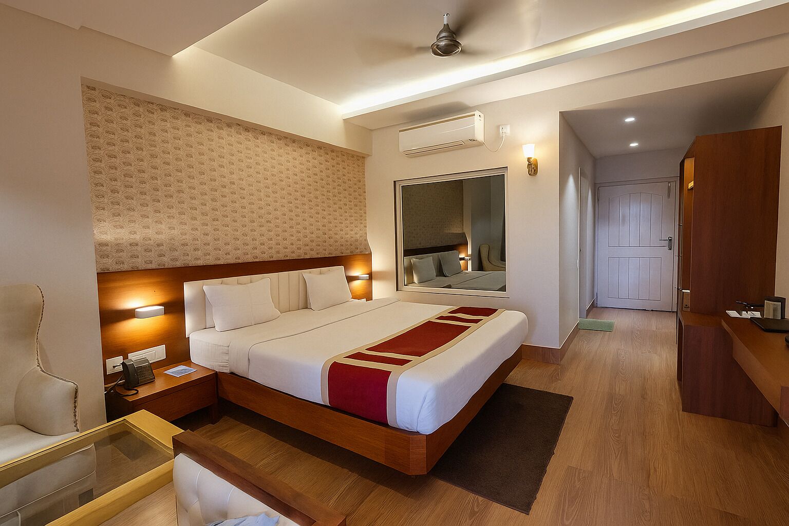 A hotel room with a large bed, bedside tables, a desk, and a mirror.