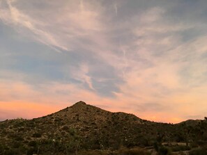 A desert landscape with a prominent hill. - Romantic Yucca Valley Cabin with Hot Tub (Yucca Valley)