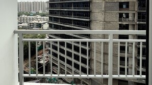 A multi-story building with a balcony. - Let'stay- NX-One Noida (Greater Noida)