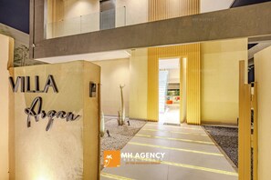 A modern hotel entrance with a sign reading "Villa Argan."