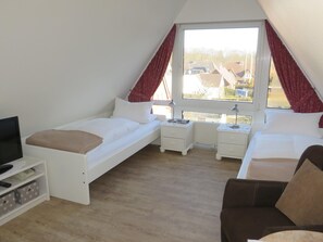 A bedroom with a loft bed, a desk, a chair, and a TV. - Gemuetliches Gruppenhaus in Wyk auf Foehr (Wyk auf Foehr)
