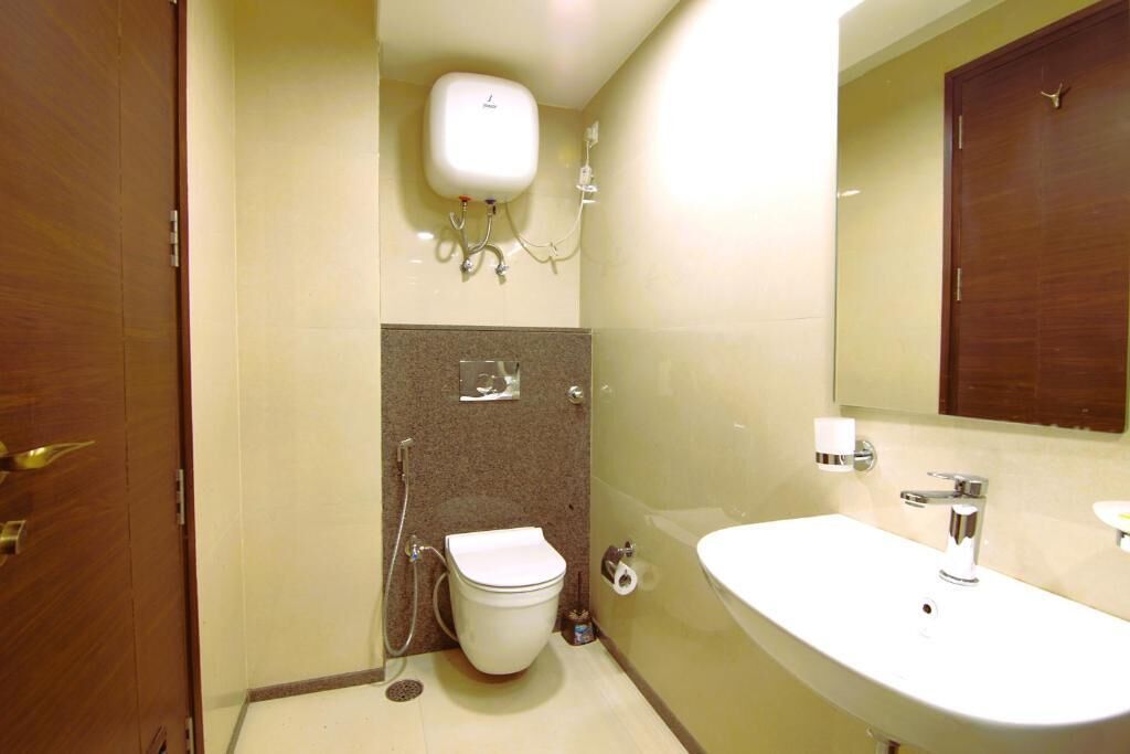 Ein Badezimmer mit Toilette, Bidet, Waschbecken und Spiegel.