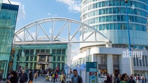 A modern building with a curved glass facade and a sign reading "BULLRING." - Cityscape Apartment in Rotunda Bham (Birmingham)