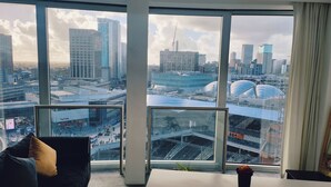 A modern hotel room with large floor-to-ceiling windows offering a city view. - Cityscape Apartment in Rotunda Bham (Birmingham)