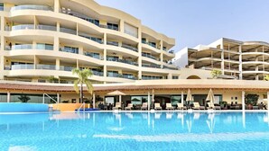 A multi-story hotel with a pool area, outdoor seating, and balconies. - Anana El Dorado 203 Condo With Lake Views Pool (Chapala)