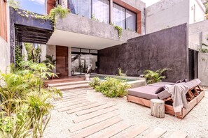 A modern outdoor living area with a pool, wooden deck, and lounge seating. - Anana Casa Karmond Luxury Villa With Pool (Tulum)